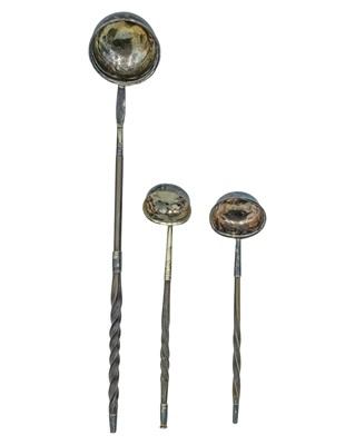Lot 86 - A trio of twisted baleen-handled toddy ladles.