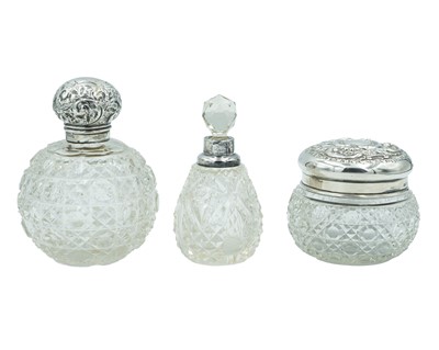 Lot 307 - Three silver-mounted dressing table bottles and jars.