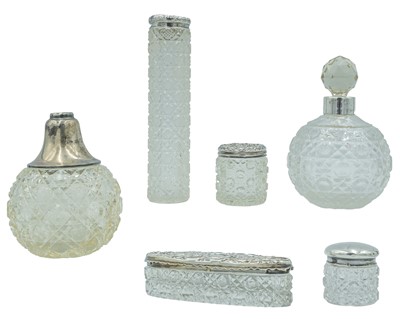 Lot 81 - A selection of early twentieth-century silver lidded scent bottles.