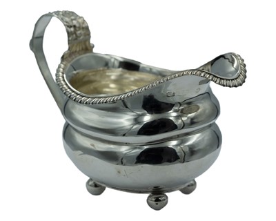 Lot 327 - A Georgian silver helmet-shaped jug.
