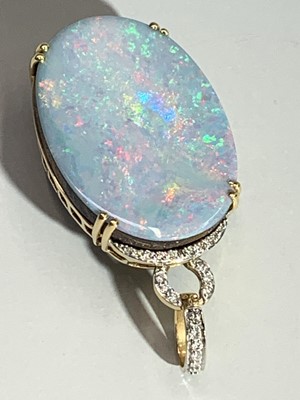 Lot 2447 - An opal doublet modern pendant set in 18ct...