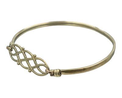 Lot 391 - A 9k gold bangle.