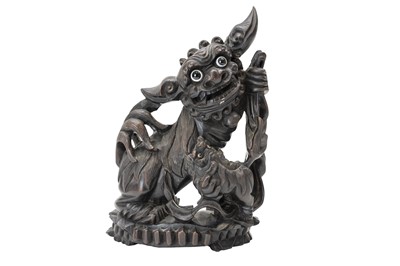 Lot 377 - A Chinese carved hardwood foo dog and pup.