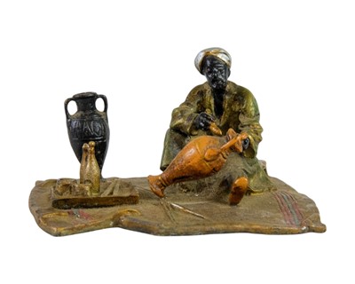 Lot 3 - A cold painted bronze figure of an Arab trader.