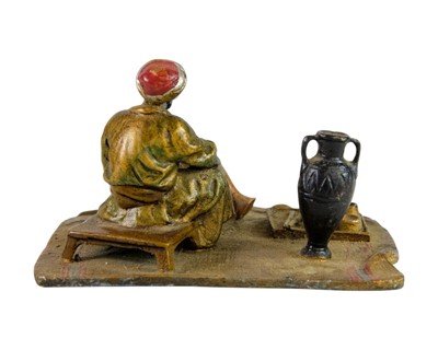 Lot 3 - A cold painted bronze figure of an Arab trader.