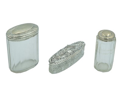 Lot 188 - A trio of Victorian and later silver-lidded cosmetic pots.