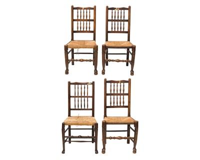 Lot 693 - A set of four Lancashire ash spindle back dining chairs.