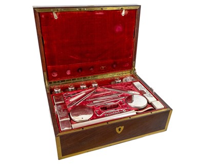 Lot 288 - A remarkable 19th-century French mahogany toilet case with silver mounted accessories.