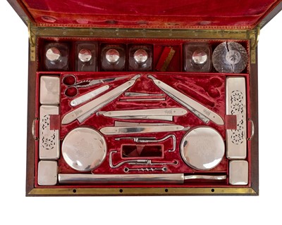 Lot 288 - A remarkable 19th-century French mahogany toilet case with silver mounted accessories.