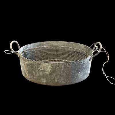 Lot 47 - A vintage steel cooking pot with a wire basket...