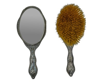 Lot 151 - A silver-backed hand mirror and hairbrush by Walker & Hall.