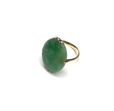 Lot 2414 - A high purity gold ring set with an oval jade...