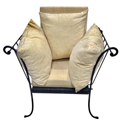 Lot 180 - A wrought iron chair with loose cushions.