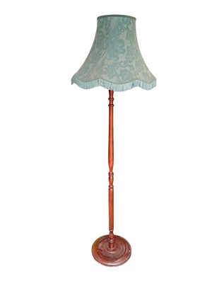 Lot 183 - A Mahogany standard lamp with a shade. It will...