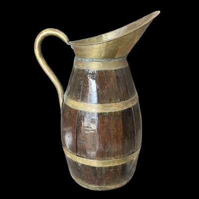 Lot 71 - A coopered oak and brass jug, 58cm overall...