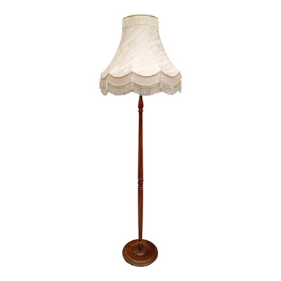 Lot 117 - A turned Oak standard lamp with shade. It is...