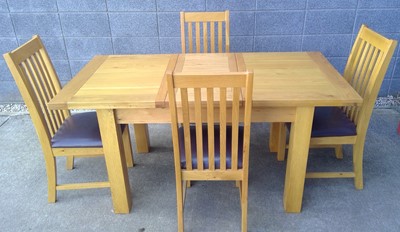 Lot 7 - A Blonde Oak Extending Dining Table and Four...