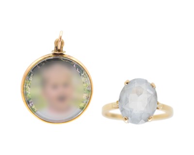 Lot 436 - A 9k ring set with an oval cut blue topaz, and a 9k hallmarked gold glazed locket pendant.