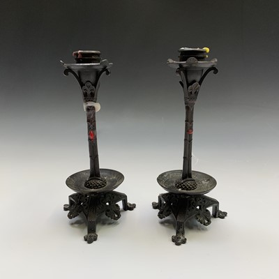 Lot 191 - A pair of bronze candlesticks, early 20th...