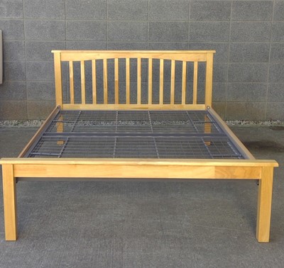 Lot 28 - A Blonde Oak Double Bedframe. The Frame is...