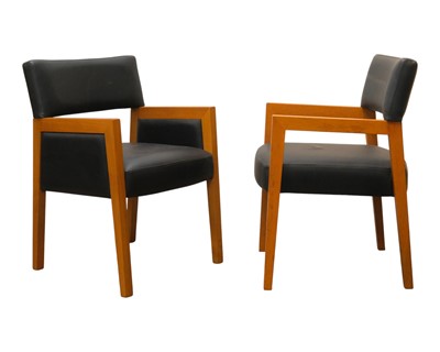 Lot 105 - Two similar oak and leather effect oak armchairs.