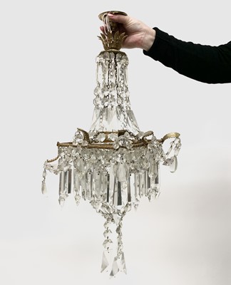 Lot 448 - A gilt metal and cut glass chandelier, with...