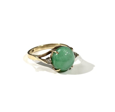 Lot 2473 - A 14ct gold ring set with jade flanked by...