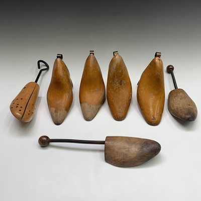 Lot 262 - Two pairs of beech and brass shoe trees,...