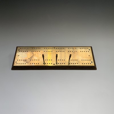 Lot 158 - A brass cribbage board, on wooden base, with...