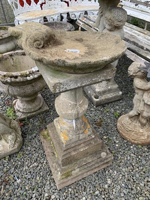 Lot 196 - A concrete urn pedestal supporting an...