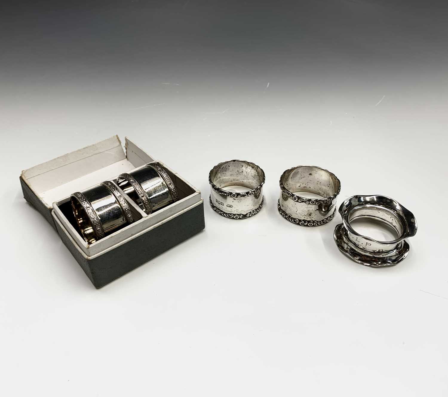 Lot 6 - Two pairs of silver napkin rings and a fifth...