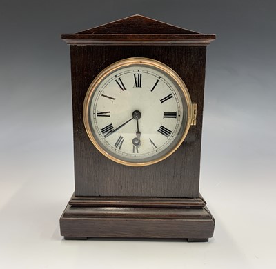 Lot 2915 - An Edwardian oak cased mantel timepiece, the...