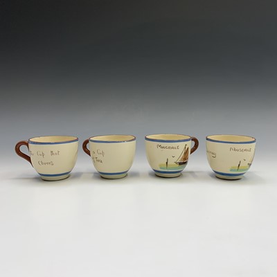 Lot 945 - A Watcombe Torquay Mottoware pottery tea and...