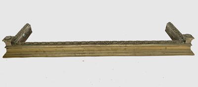 Lot 687 - An Edwardian brass fender, the top rail...