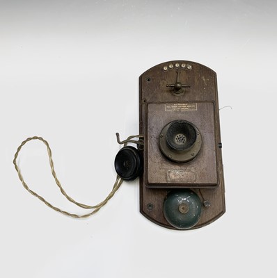 Lot 652 - A Peel Conner wall mounted walnut telephone...