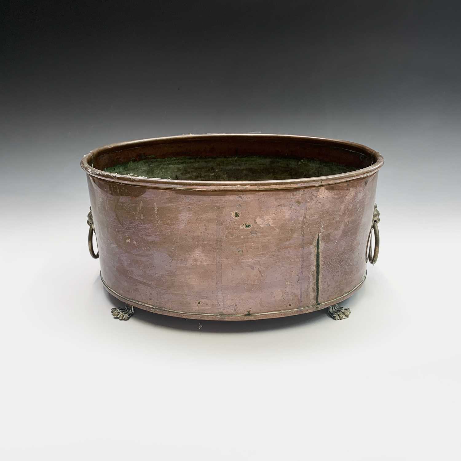 Lot 4 - A copper plant trough of oval form, with brass...