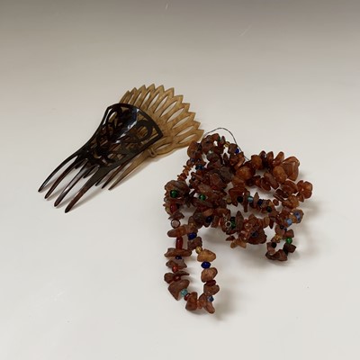 Lot 152 - Two amber necklaces and two tortoiseshell combs.