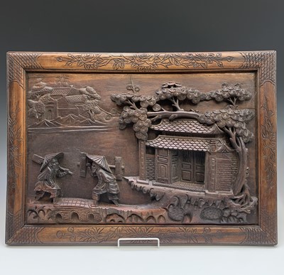 Lot 709 - A Chinese hardwood panel, carved in high...