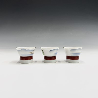 Lot 957 - Three Japanese Saki cups, 20th century, each...