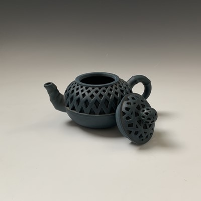 Lot 157 - A Chinese yixing pottery reticulated teapot,...