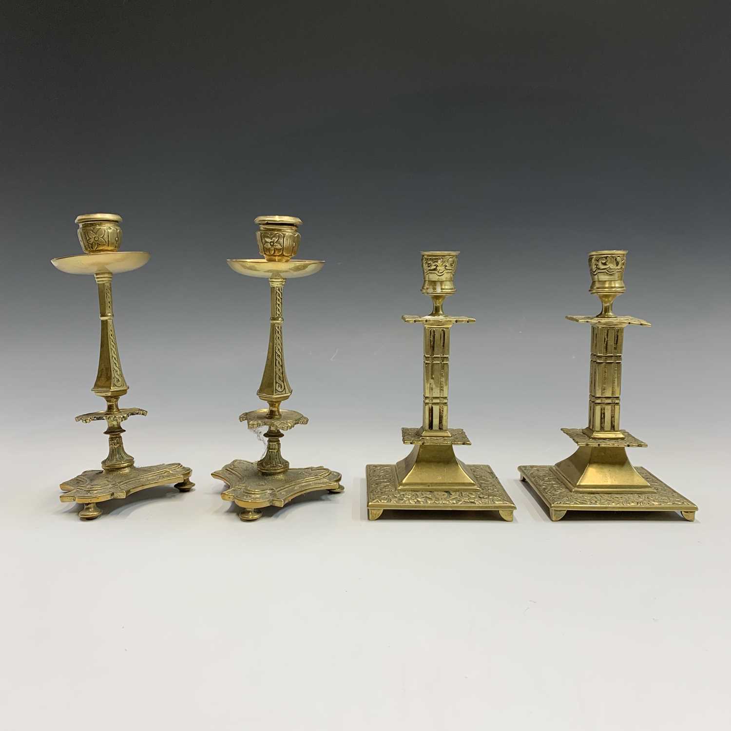 Lot 256 - A pair of 19th century cast brass candlesticks,...