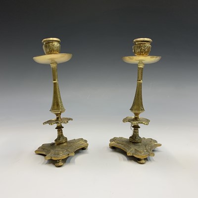 Lot 256 - A pair of 19th century cast brass candlesticks,...