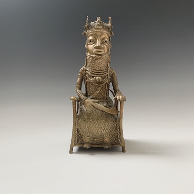 Lot 216 - A Bennin bronze model of a seated chief,...