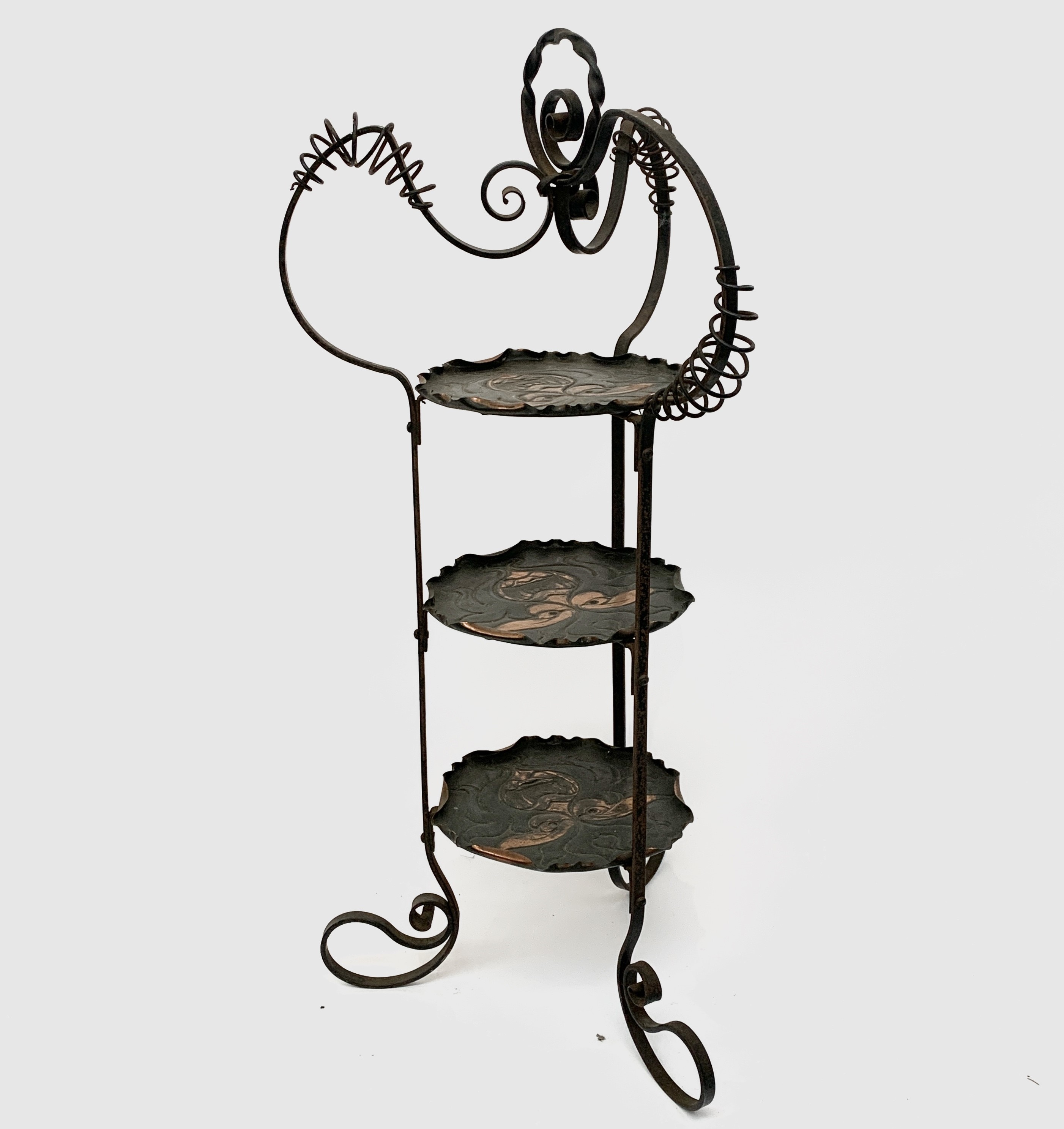 Lot 163 - An Arts and Crafts wrought iron cake stand,
