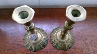 Lot 43 - A pair of George III brass candlesticks with...