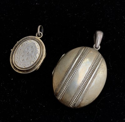 Lot 666 - Two silver lockets