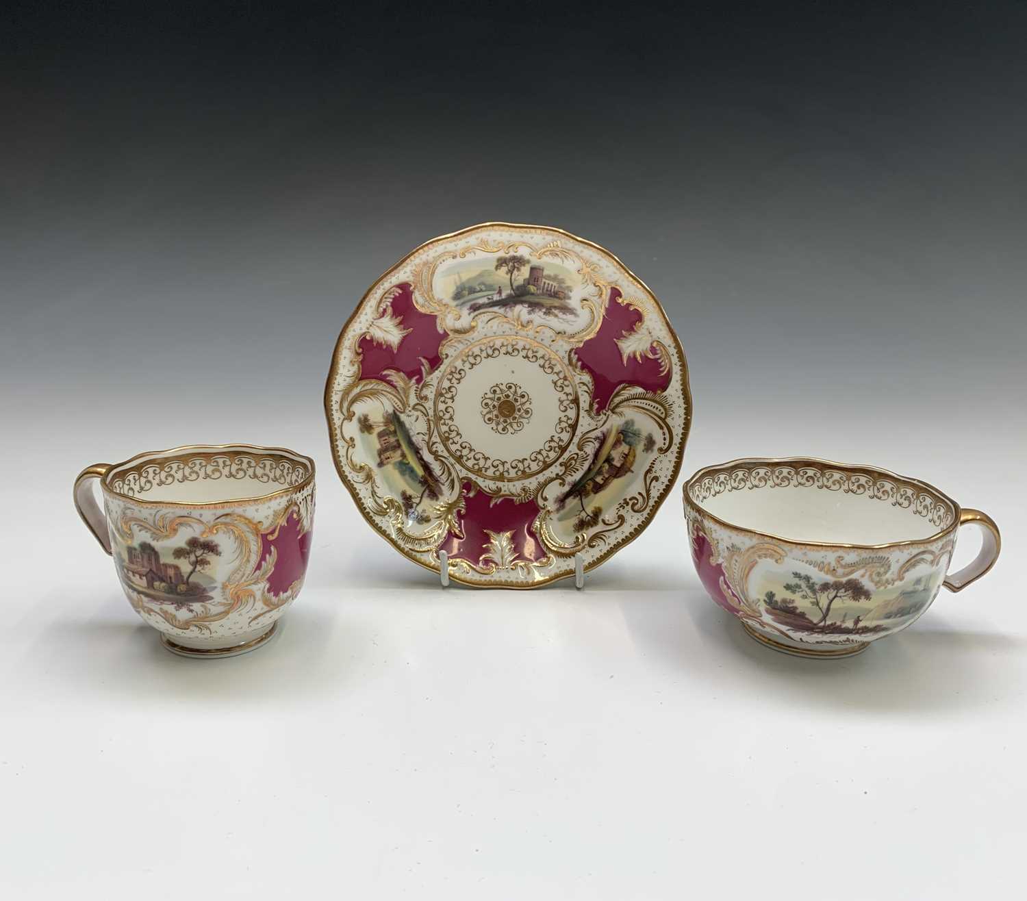 Lot 857 - A Minton porcelain trio, painted with bucolic...