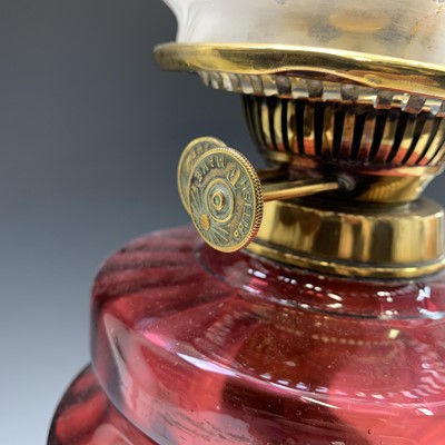 Lot 81 - A Victorian brass oil lamp, with cranberry...