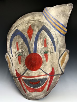 Lot 691 - A clown head painted on wood. 86cm x 60cm...