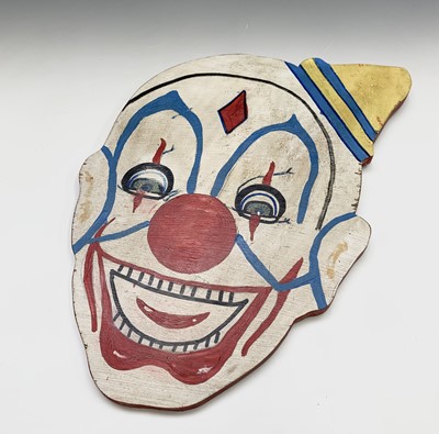 Lot 690 - A clown head painted on wood. 52cm x 35cm...